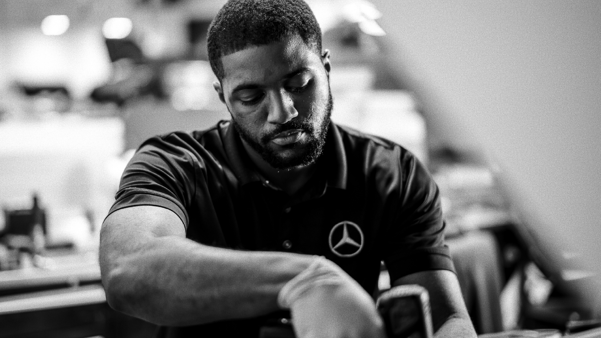 Mercedes Benz male mechanic working on car.