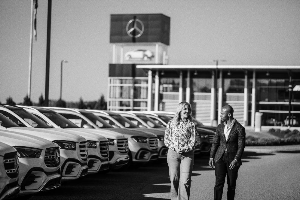 Mercedes Benz woman and man walking at dealership.